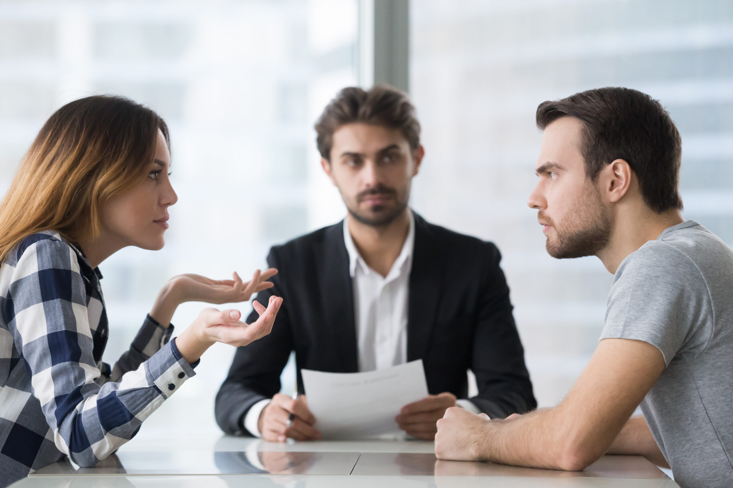 A man and woman argue during a consultation with a solicitor.