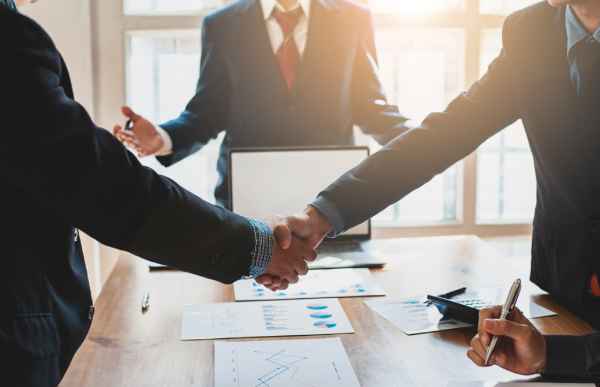 A landlord and tenant shake hands after resolving a dispute.