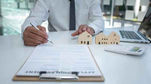 A businessman signs a contract to purchase a commercial property.