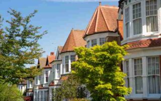 A row of traditional English terraced houses, pictured on a sunny day.