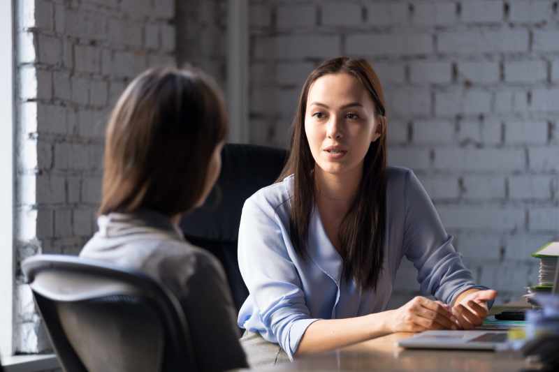 A young female solicitor advises a female client on their unfair dismissal claim.