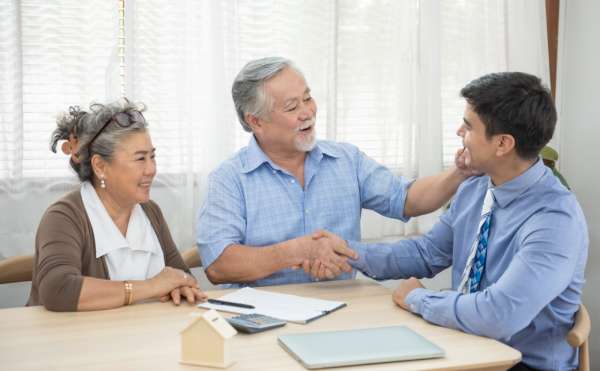 An elderly couple consult with a solicitor on Lasting Powers of Attorney.