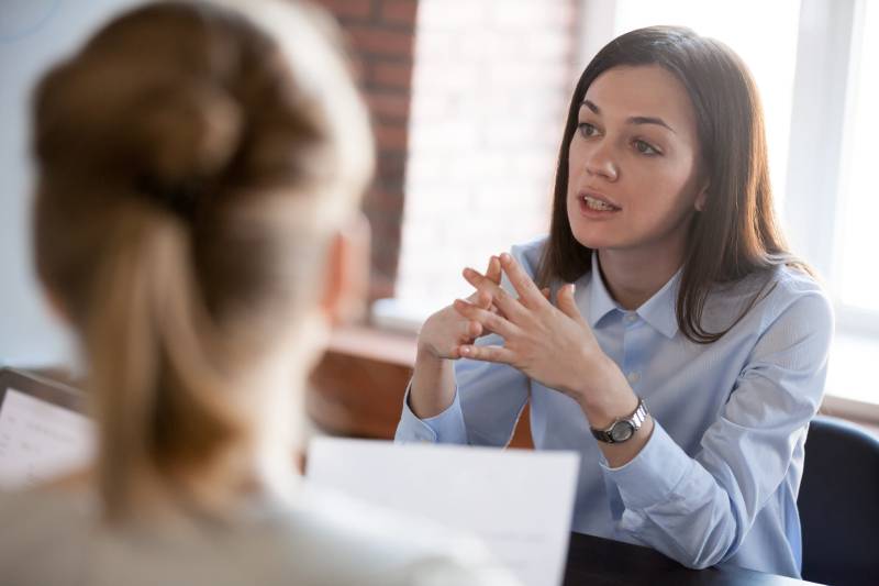 A businesswoman engages with her colleagues in a business meeting.