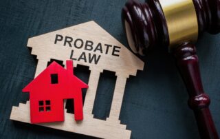 a small wooden house that says probate law next to a judge's hammer